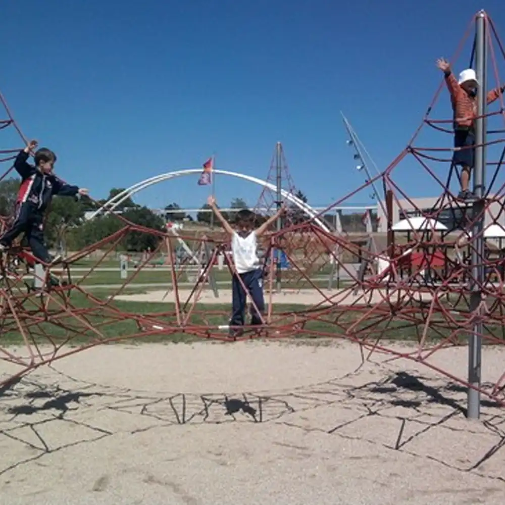 Niños y adultos disfrutan de un parque con estructuras de escalada en la Serra da Estrela.