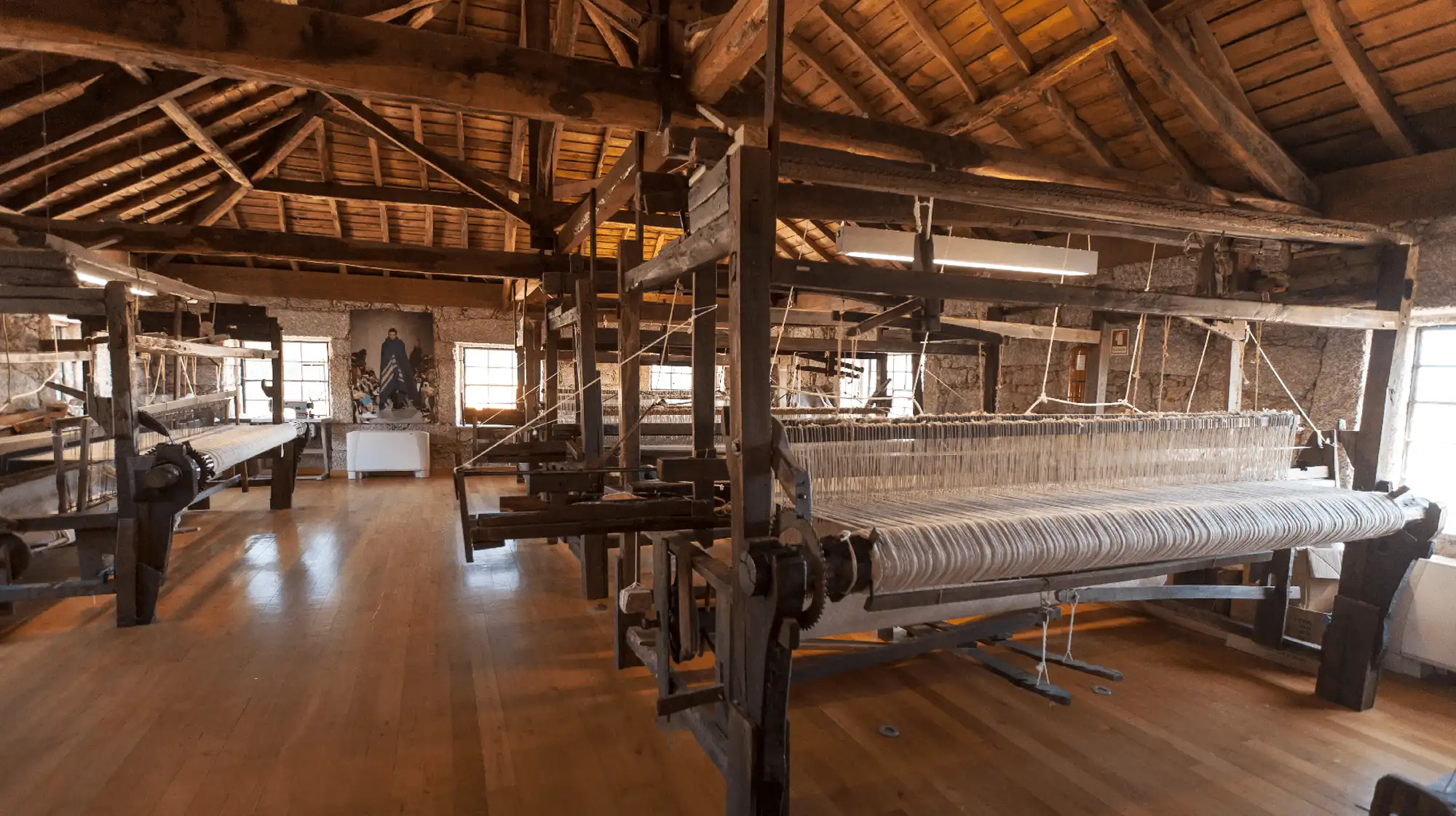 Exhibition display inside a Serra da Estrela museum showing traditional tools and cultural artifacts.