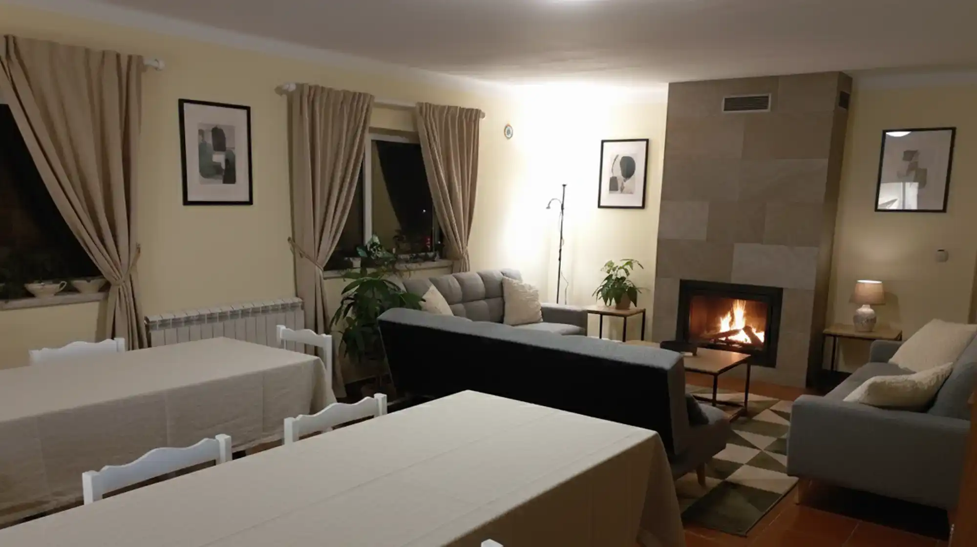 Cosy shared lounge room at Starbase18 with sofas, books, and board games, set up for relaxation or group dining